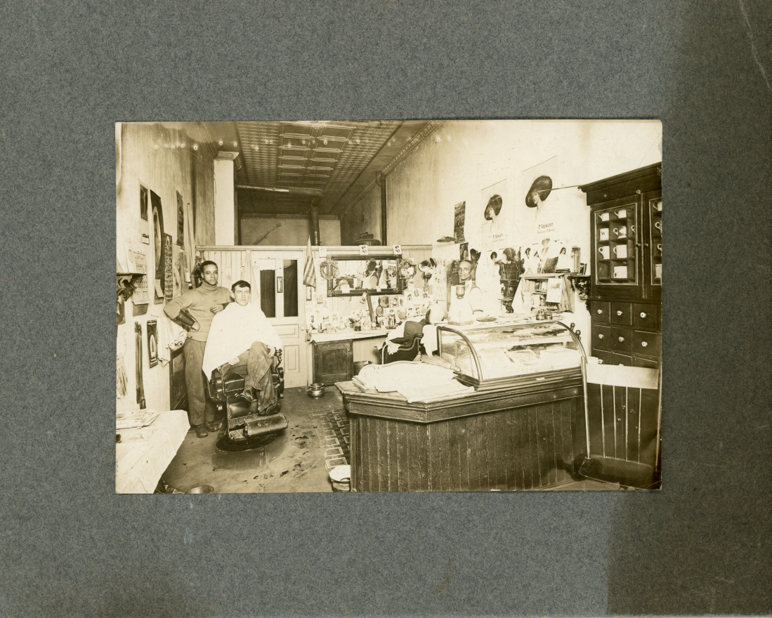 John Johnson stands at the far right in his barber shop in 1912. Lumber workers, a very popular profession in the region at that time, could get a haircut and take a bath in Johnson's shop.